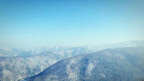 Scenic view of mountains against clear blue sky