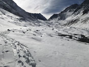 Scenic view of snow covered mountains against sky