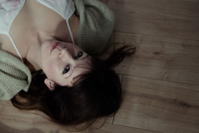 High angle view of cute girl lying on bed at home