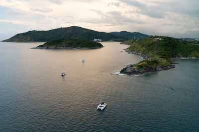 High angle view of sailboats by sea against sky