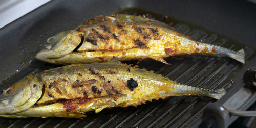 High angle view of meat on barbecue grill