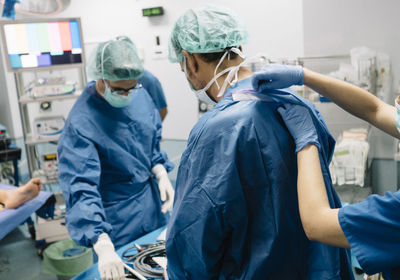 Rear view of doctor examining patient in hospital