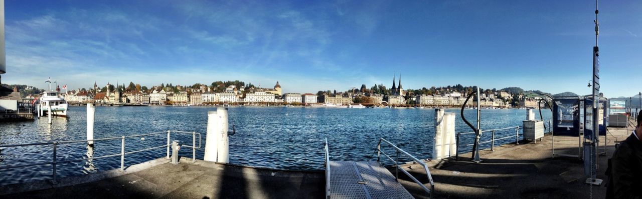 water, nautical vessel, sky, blue, sea, built structure, transportation, boat, railing, architecture, building exterior, harbor, pier, mode of transport, day, moored, river, outdoors, men