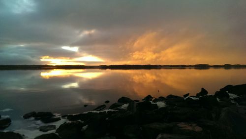 Scenic view of lake at sunset