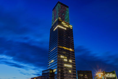 Low angle view of illuminated buildings against sky at night