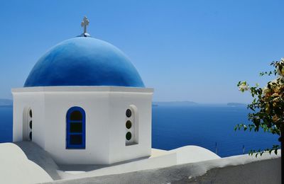 Anastasi church by sea against clear blue sky