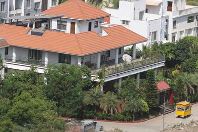 Houses by street and buildings in city