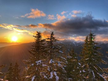 Scenic view of snow covered mountains against sky during sunset