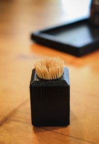 Close-up of toothpicks in container on table at restaurant