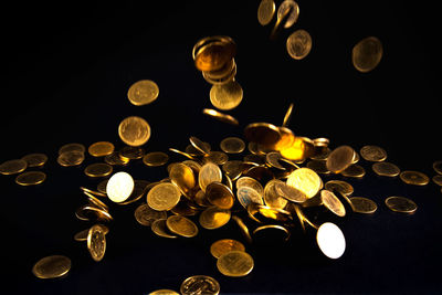 Close-up of lit candle against black background