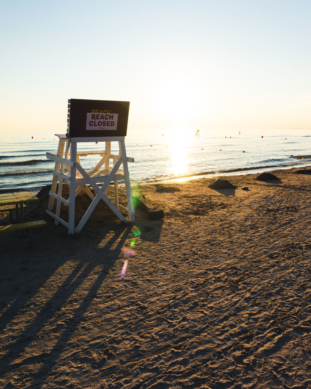 VIEW OF TEXT ON BEACH AGAINST SKY DURING SUNSET