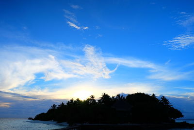 View of calm beach against blue sky