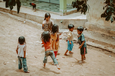 Group of people and children on ground