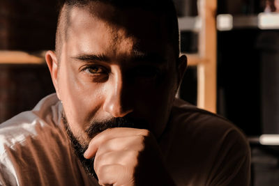 Portrait of young man looking straight into the camera concentrated, focused and serious