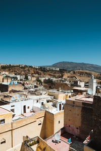 High angle view of townscape against clear blue sky