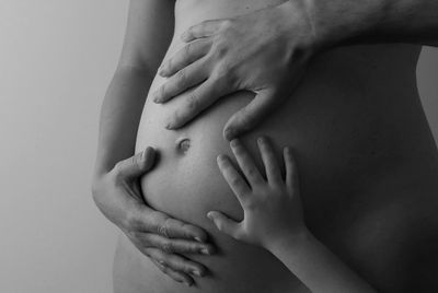 Hands touching a pregnant belly