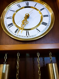 Low angle view of clock on window in building