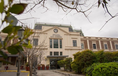Street by buildings against sky