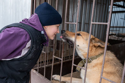 Girl volunteer in the nursery for dogs. shelter for stray dogs.