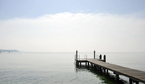 Pier over sea against sky