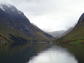 Scenic view of lake and mountains against sky