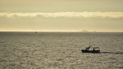 Sailboat sailing on sea against sky