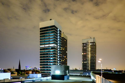 Modern buildings against sky at dusk