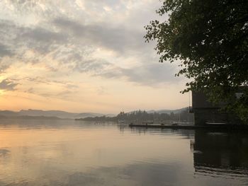 Scenic view of lake against sky at sunset