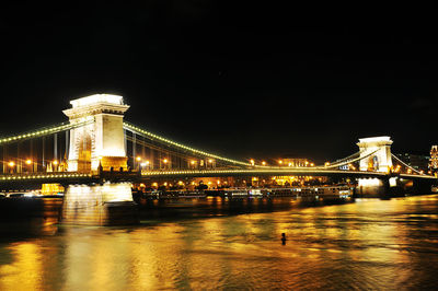 Illuminated bridge at night