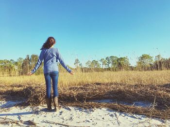 Man standing on field against clear sky