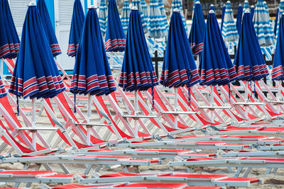 Closed canopies and sun loungers on beach