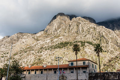 Low angle view of building and mountains against sky