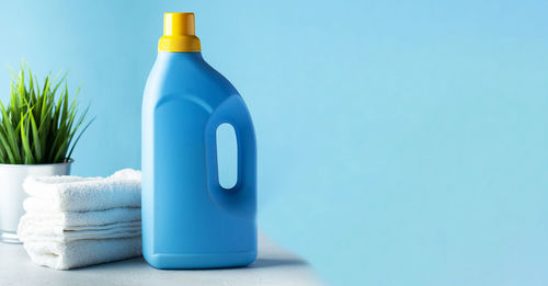 Mockup blue bottle with laundry detergent on a blue background. copy space.