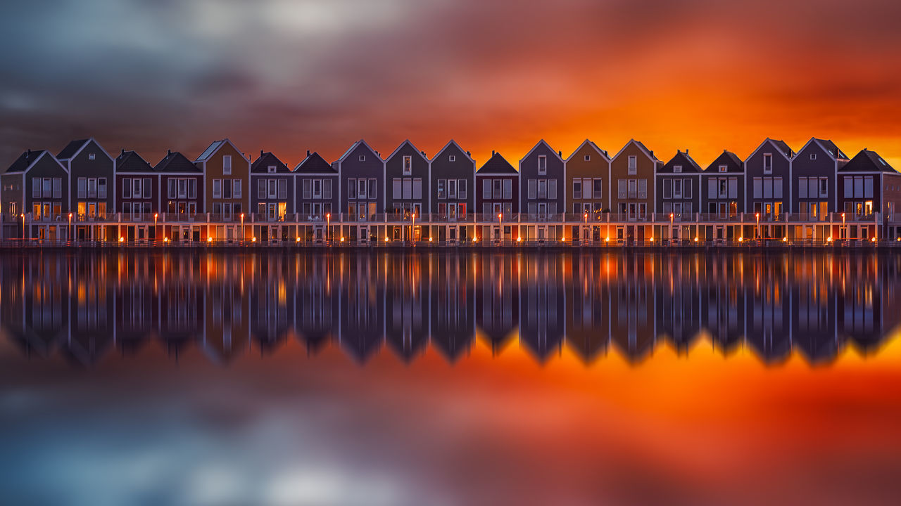 water, sky, architecture, sunset, built structure, orange color, nature, no people, reflection, sea, cloud - sky, beauty in nature, building exterior, scenics - nature, waterfront, building, side by side, outdoors