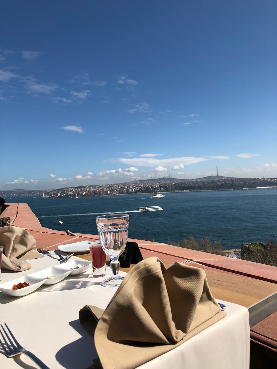 water, sky, food and drink, no people, table, glass, nature, sea, drink, day, cloud - sky, sunlight, refreshment, drinking glass, nautical vessel, business, freshness, household equipment, outdoors