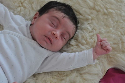 High angle view of baby sleeping on bed