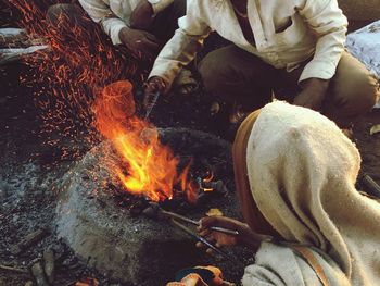 High angle view of workers by fire pit