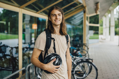 Portrait of smiling young woman on bicycle