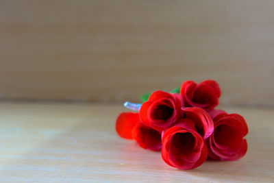 Close-up of red rose on table