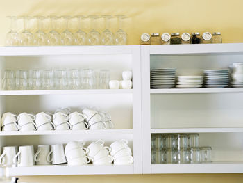 Crockery arranged on shelves at home