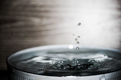 Close-up of drops falling in container