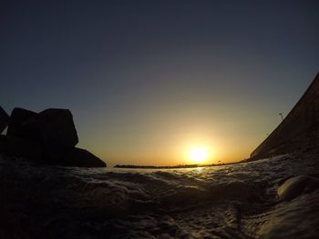 Scenic view of sea against clear sky during sunset