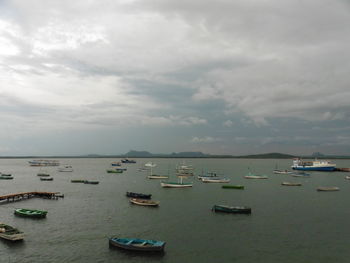 Boats sailing in sea against sky