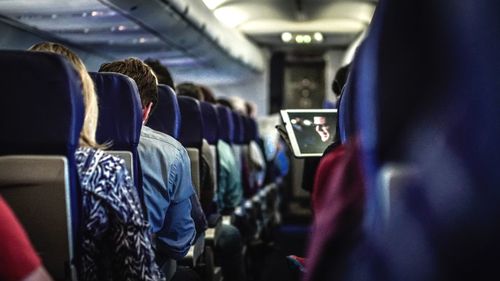 Rear view of people in airplane