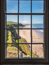 Scenic view of sea seen through glass window