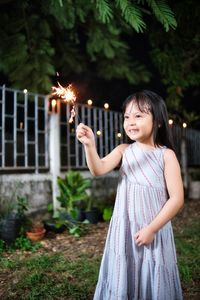 Child playing fireworks in new year celebration at night