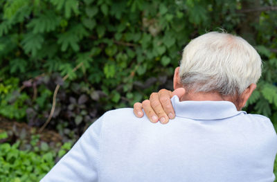 Rear view of man with arms raised