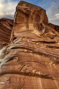 Low angle view of rock formation against sky