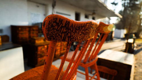 Close-up of red and chairs on table against building