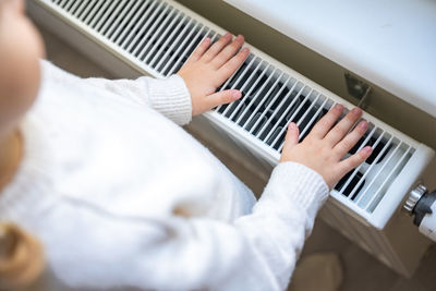 Cropped hand of woman using laptop